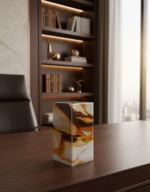 Amber gold agate-finish wooden column vase lit by a brass desk lamp