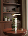 Ivy green and white mosaic wooden column vase on a round walnut table